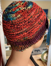 handknit wool hat with quilted and beaded pin